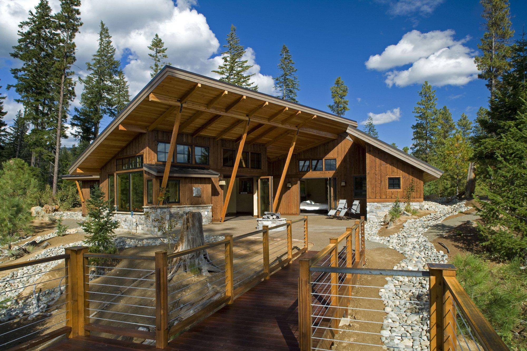 a large wooden house with a wooden deck.