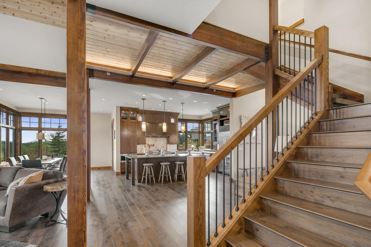 a living room filled with furniture and a staircase.