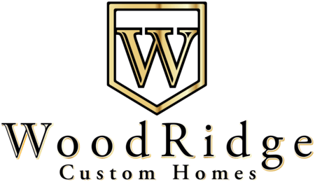 Gold and black logo for WoodRidge Custom Homes, featuring a stylized "W" inside a shield above the company name in elegant serif font.
