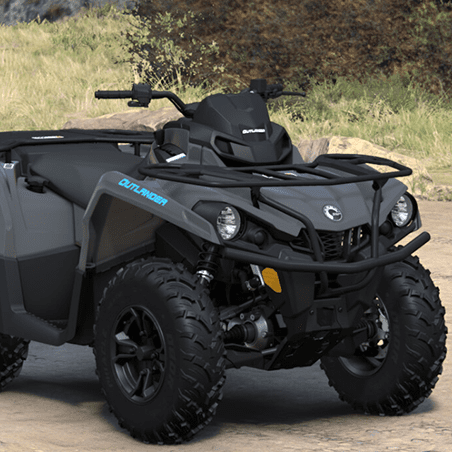 A black and gray Can-Am Outlander all-terrain vehicle is parked outdoors on a dirt path with grass and rocks in the background.