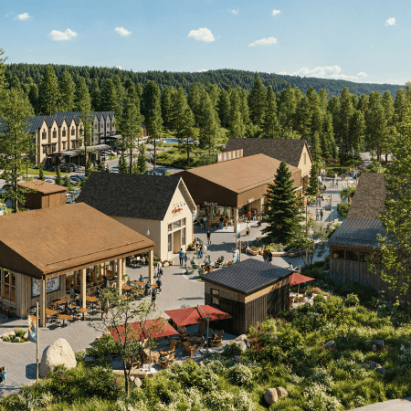 A vibrant outdoor market square surrounded by rustic buildings, shops, and cafes with people walking and dining, set among pine trees and greenery in a forested area.